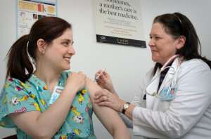 nurse receives flu vaccine