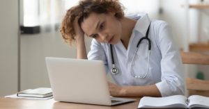frustrated doctor with laptop